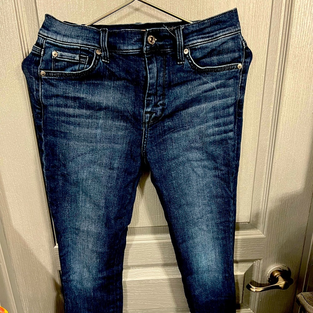 Dark jeans with black appliqué on ankle